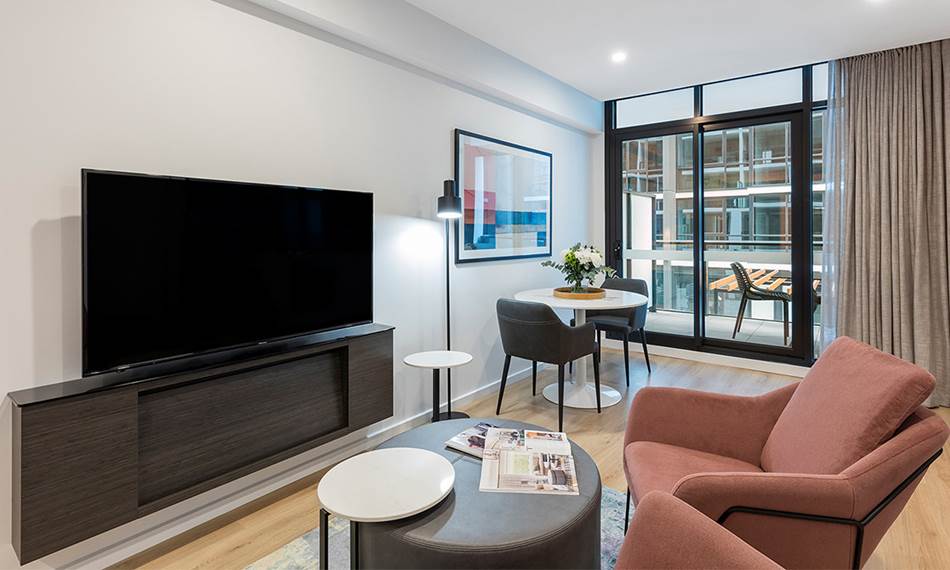 Living Room Equipped with TV and Study Table and home comforts at Avani Adelaide