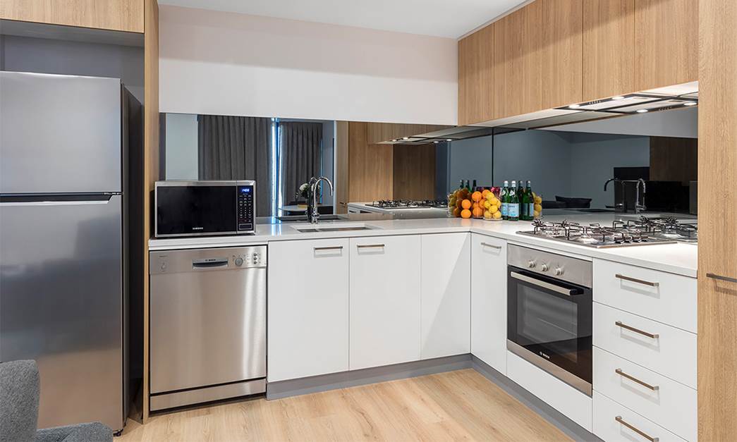 Fully equipped modern kitchen with Fridge, cook-top, oven and microwave