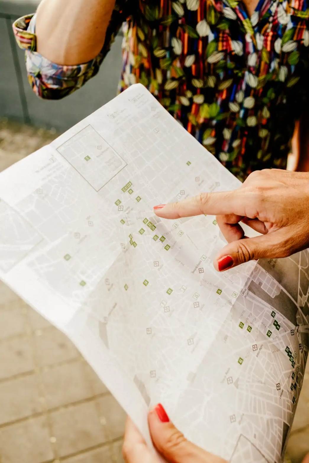 A finger being pointed on a map.