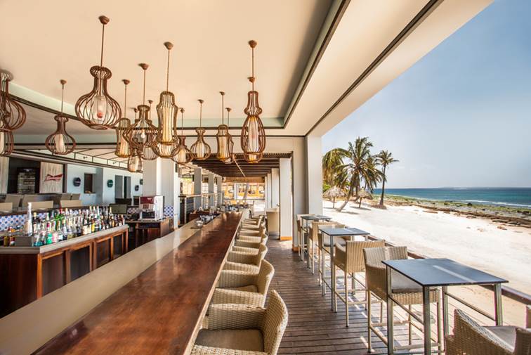 A beachfront restaurant, overlooking white sand and turquoise water