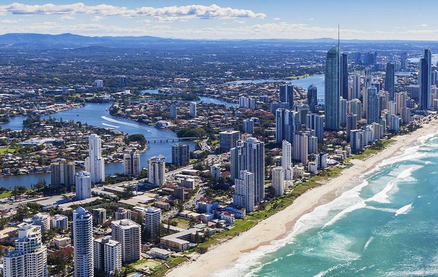 Aerial view capturing the city's skyline and the expansive stretch of Broadbeach, showcasing the blend of urban and coastal landscapes