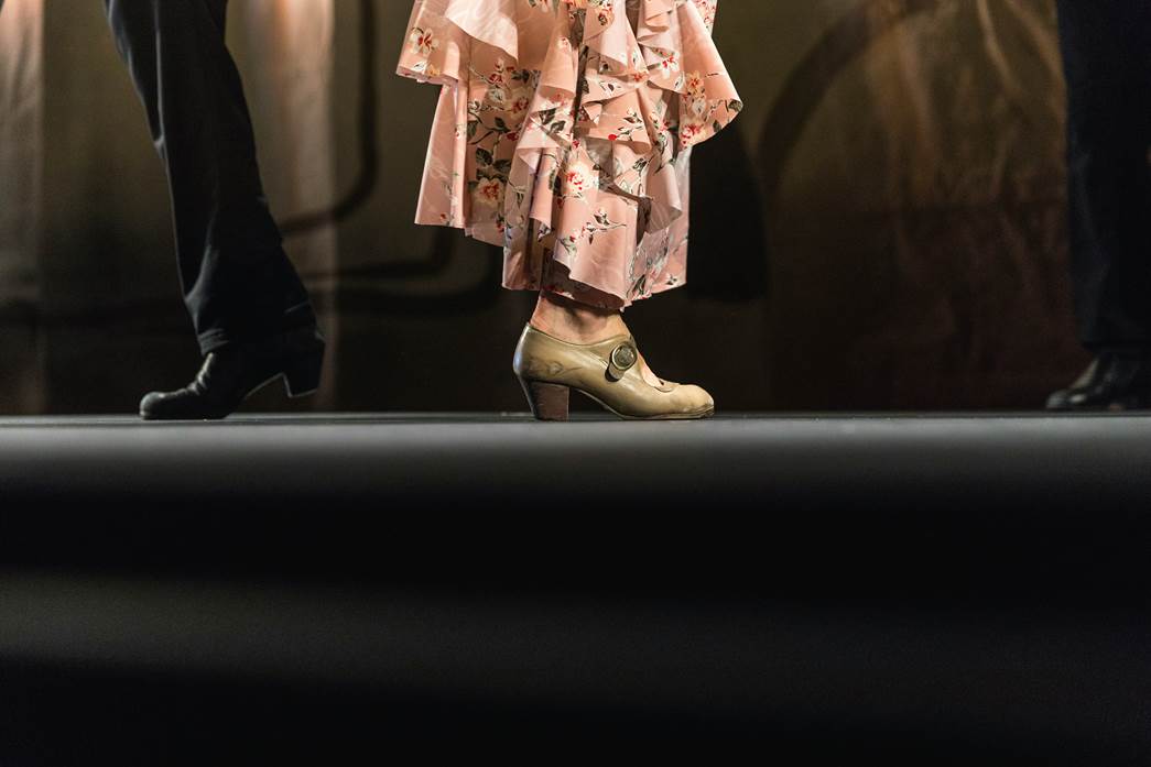 Two pairs of feet of flamenco dancers.