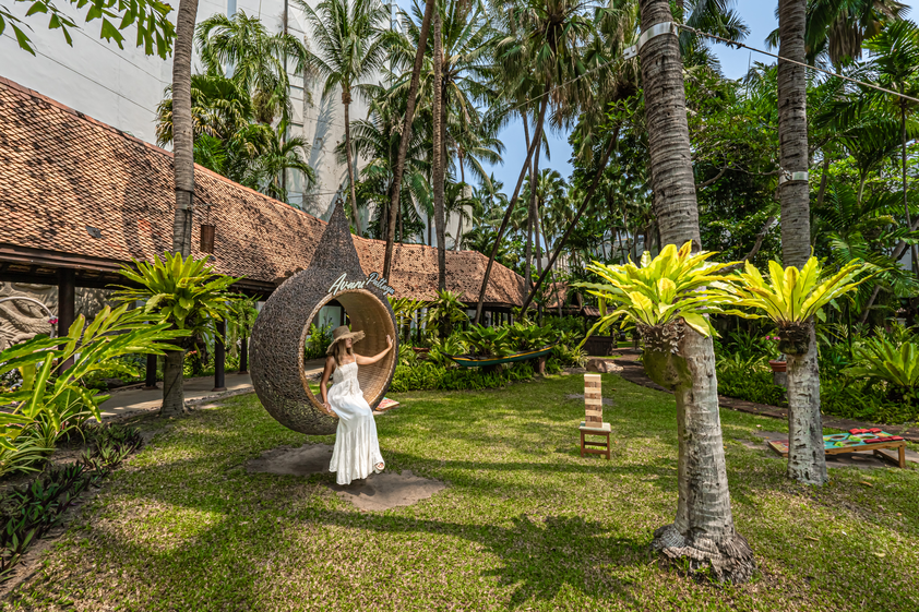 A woman sitting in the garden at Avani Pattaya Resort.