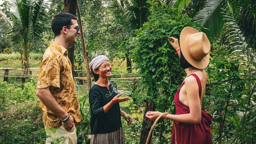 Unn Sophary laughing and sharing a joyful moment with a man and a woman, during a meeting at Herbal Kulen.