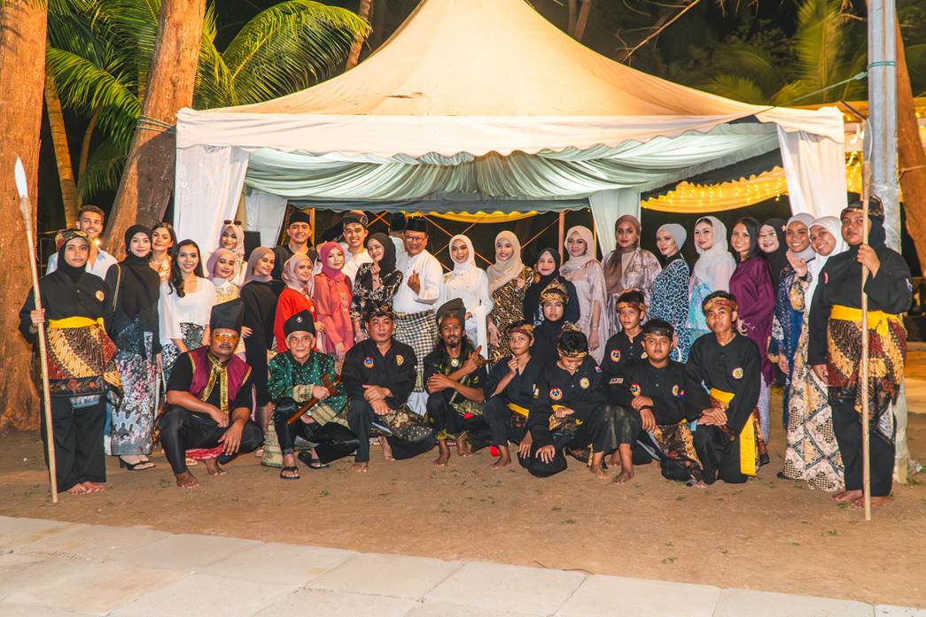 A group of people, some in Silat uniform.
