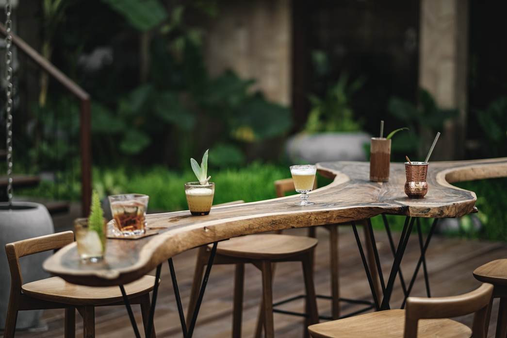 Several drinks laid out at an outdoor table at Scribe Bar.