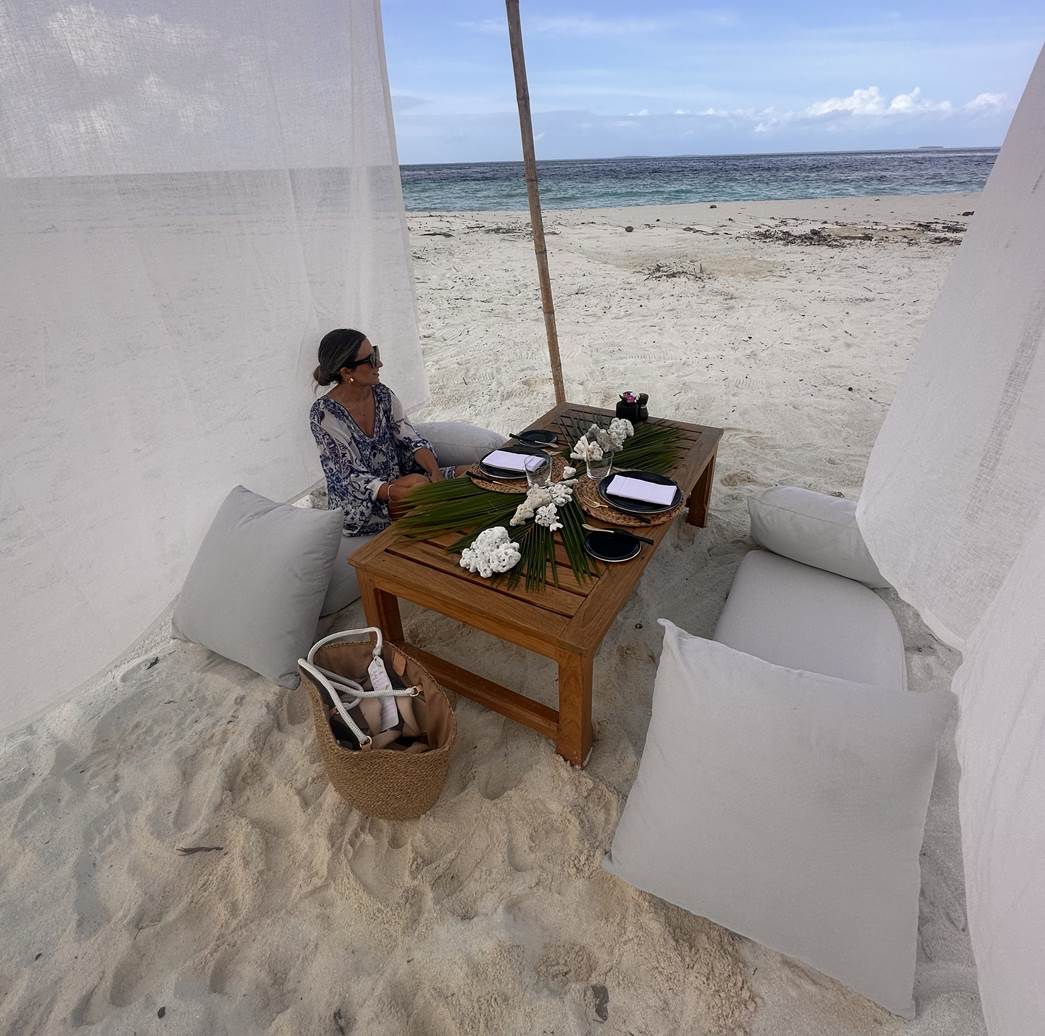 Adrift Dinner on the beach with the sand beneath and the ocean waves