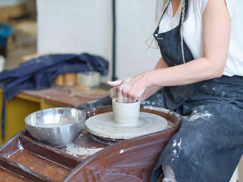 Woman making clay pottery in a pottery class at Siem Reap