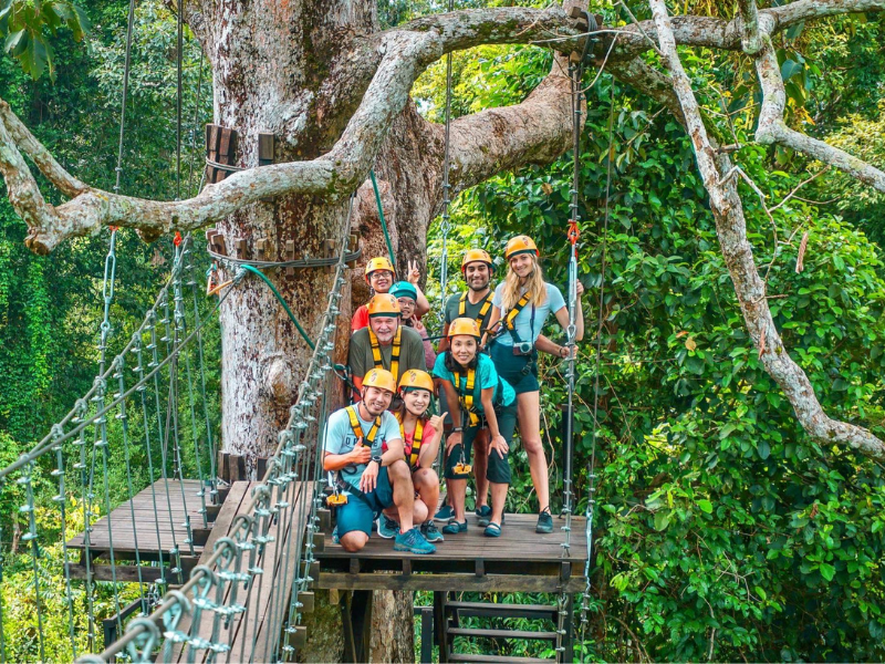 A group of family on a zipline tree at Angkor Zipline in Siem Reap