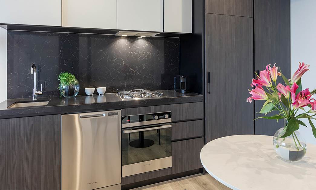 Fully equipped modern kitchen with fridge, cook top, oven, microwave, dishwasher and toaster