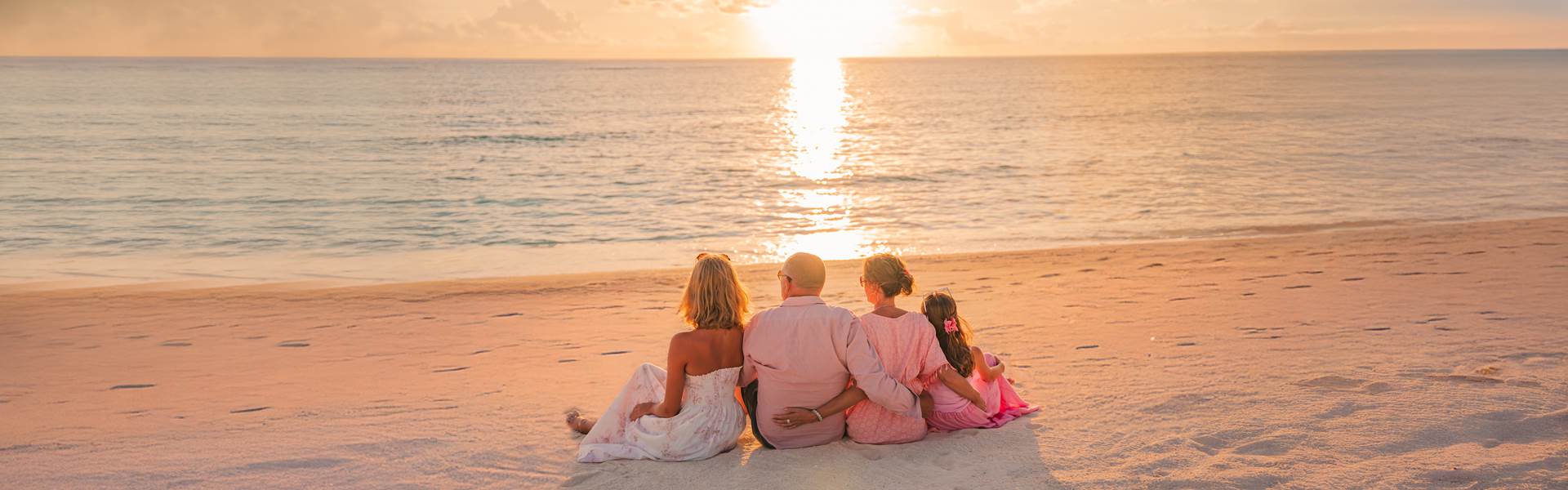 Family watching the sunset at Avani+ Fares Maldives Resort